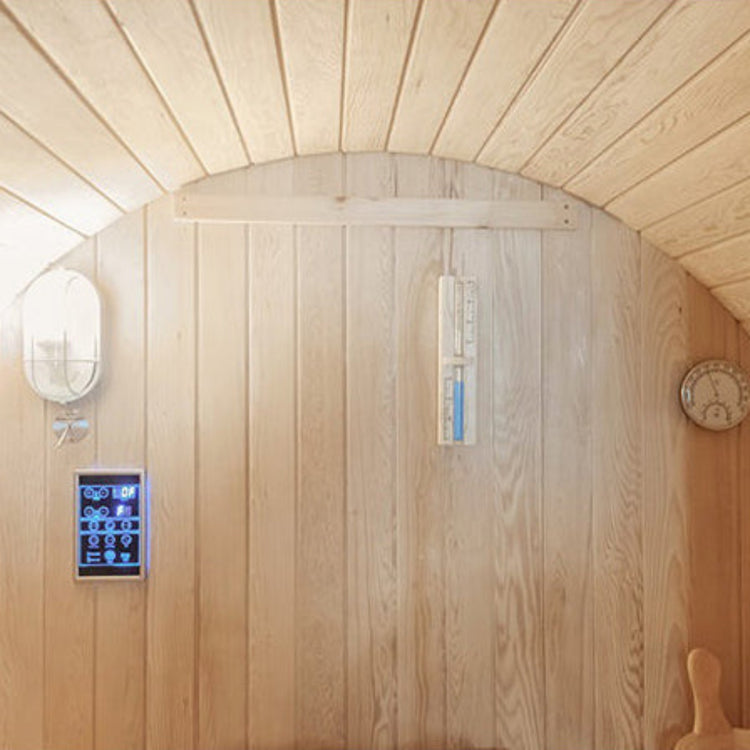 Wooden sauna interior with digital control panel and thermometer.