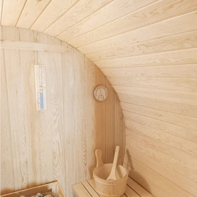 Wooden sauna interior with a bucket and wooden spoon.