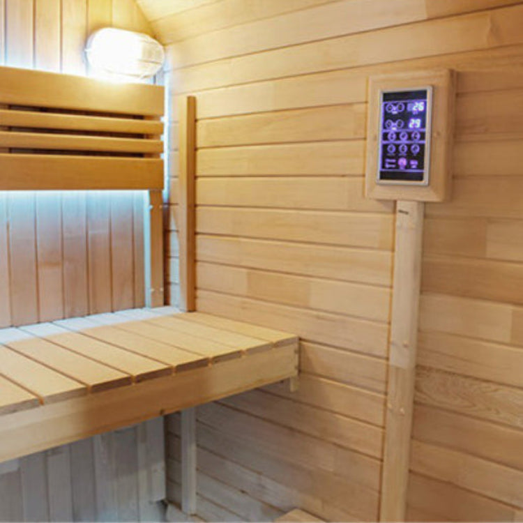 Wooden sauna interior with a digital control panel on the wall.