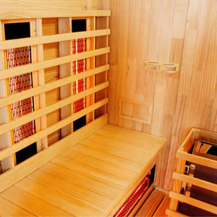 Wooden sauna interior with bench and infrared panels