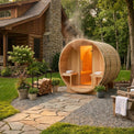 Wooden outdoor sauna in a garden setting with a house in the background